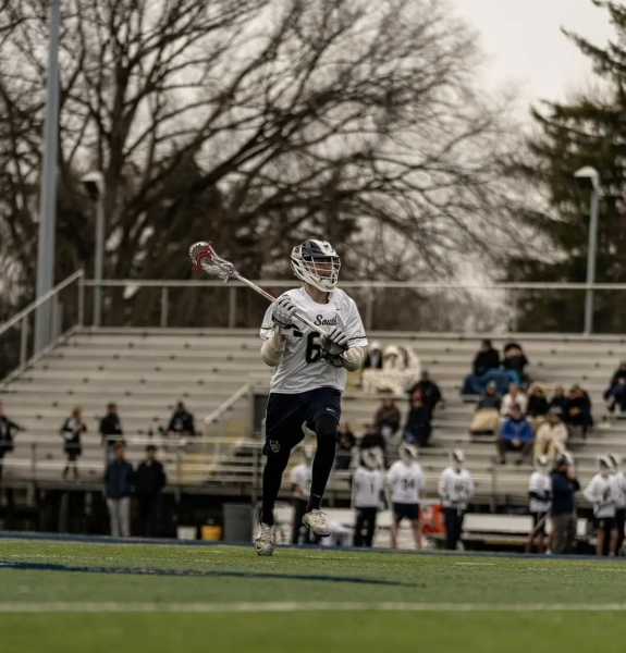Pack the Den: The same bleachers that were overflowing for the football games are now scattered with just a few people for the varsity boys lacrosse game. Photo courtesy of Thaddeus Houk ’28.
