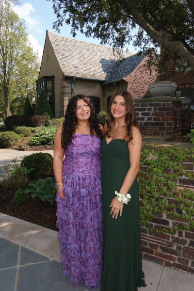 Picture perfect: Seniors Mackenzie Adams and Vivi Cilano show off their prom dresses. Adams made sure to present the beautiful floral pattern of her dress, which she loved.
Photo courtesy of Mackenzie Adams