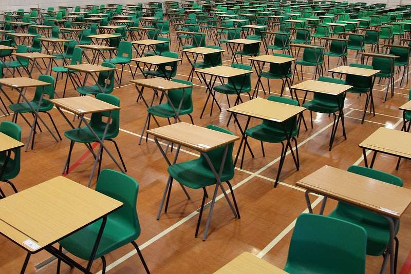 Hello neighbor: Desks are arranged in rows upon rows of students sitting right next to one another. 
Photo courtesy of: Pixibay.com