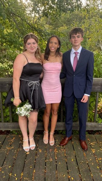 Hoco Fun: Freshmen Evelyn Kraydich, Khloe Mills and Lee Anderson take a quick photo at Patterson Park before rushing over to dinner. All the girls in their homecoming group wore their heels to the dance and quickly learned their best option was to go barefoot. Photo courtesy of: Marielle Macuga